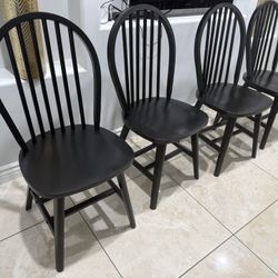 4 black solid wood chairs  Dimensions: H 36.72 in, W 17.91 in, D 20.57 in 