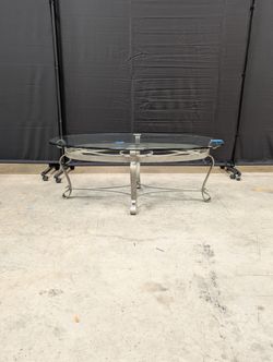 Oval Glass Top Coffee Table with Ornate Scrolled Metal Base