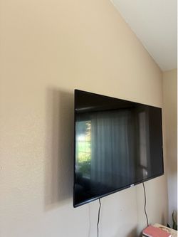 TCL 55 inch TV with wall attachment