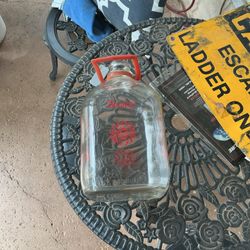 A gallon glass milk jug 