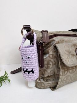 Amigurumi hand sanitizer holder. crochet hand sanitizer pouch. body lotion holder. bag charm. backpack hand sanitizer holder. gel disinfectant
