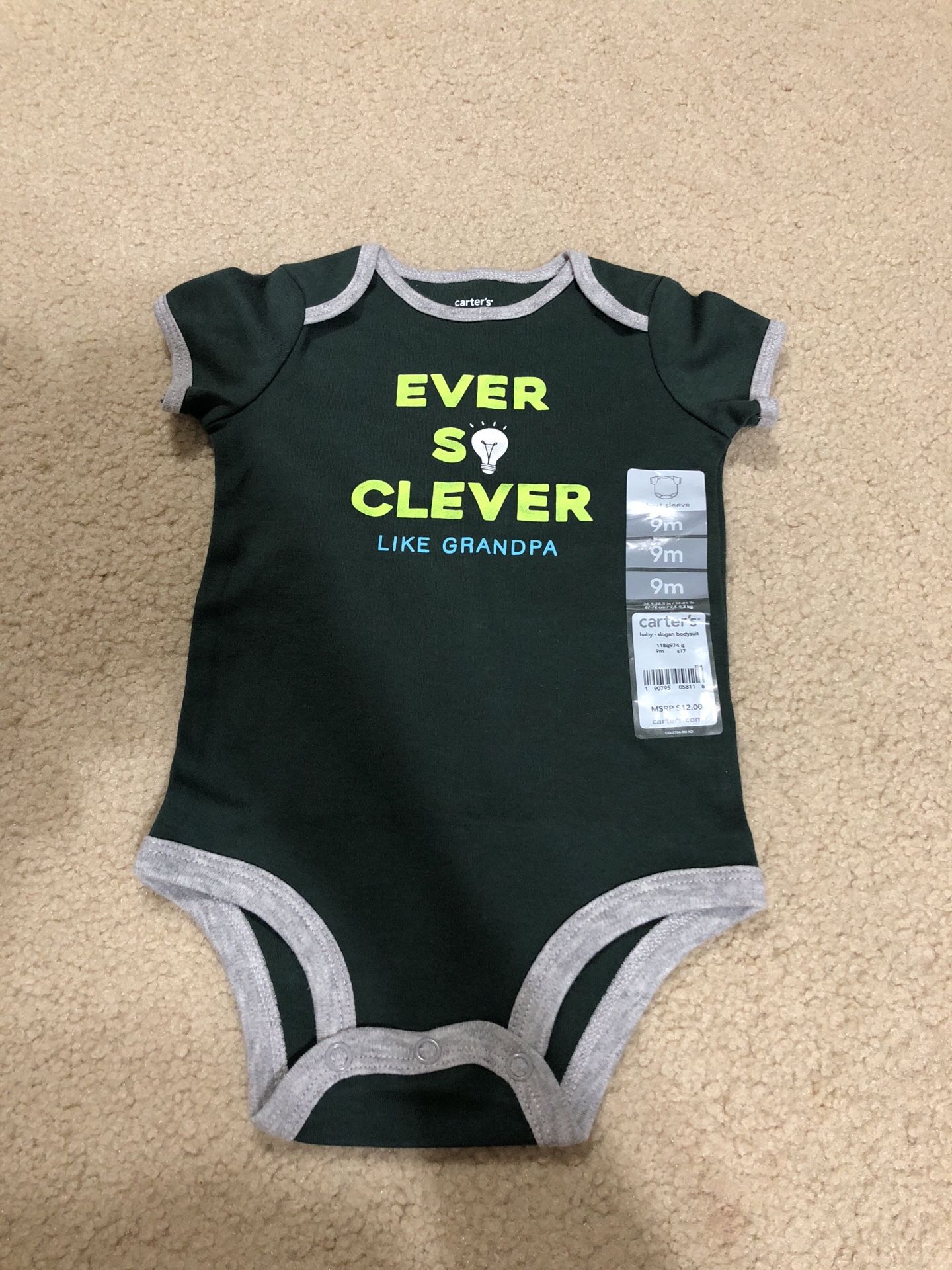 BRAND NEW: Carter’s onesie in size 9 Months