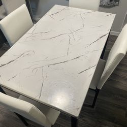 very nice white table with cat damaged chairs