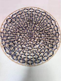 wall hanging basket with a concentric open-weave design.
