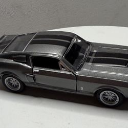 A collectible model car depicting the 1967 Ford Mustang Shelby GT500.