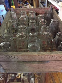 Antique milk bottles and wooden crate