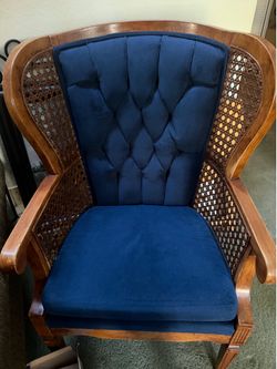 Two wood with blue cloth chairs.
