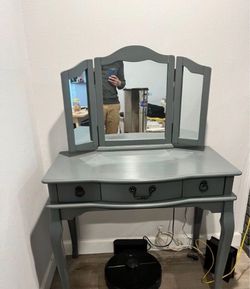 Gray makeup vanity with 3 drawers and mirror