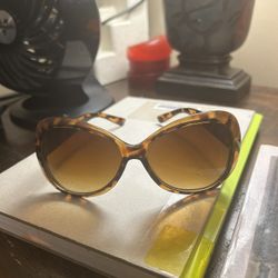 a pair of women's oversized cat-eye sunglasses with a brown tortoise shell frame 