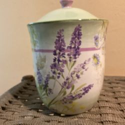 The ceramic canister with a floral design is a charming addition to any kitchen or home collection. Its intricate pattern and delicate design make it 