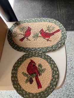Two Christmas cardinal braided trivets