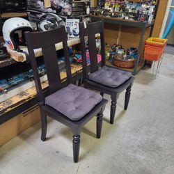 Pair of high-back chairs. Heavy, black. With or without these cushions shown