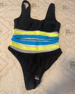 Two piece swimsuit in black with neon and blue band  color . It’s new without tags