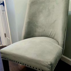 2 sage green chairs, featuring luxurious fabric, elegant bronze nailhead trim, cherry Legs