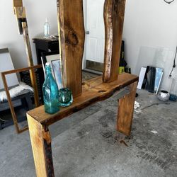 thin minimalist console table and live edge mirror