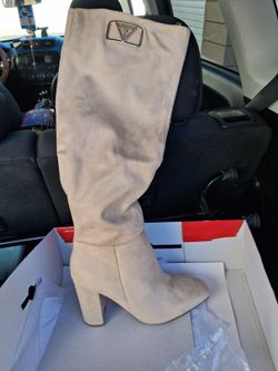 Brand New in the box solid white GUESS knee high with the Gold GUESS logo on the side never been used