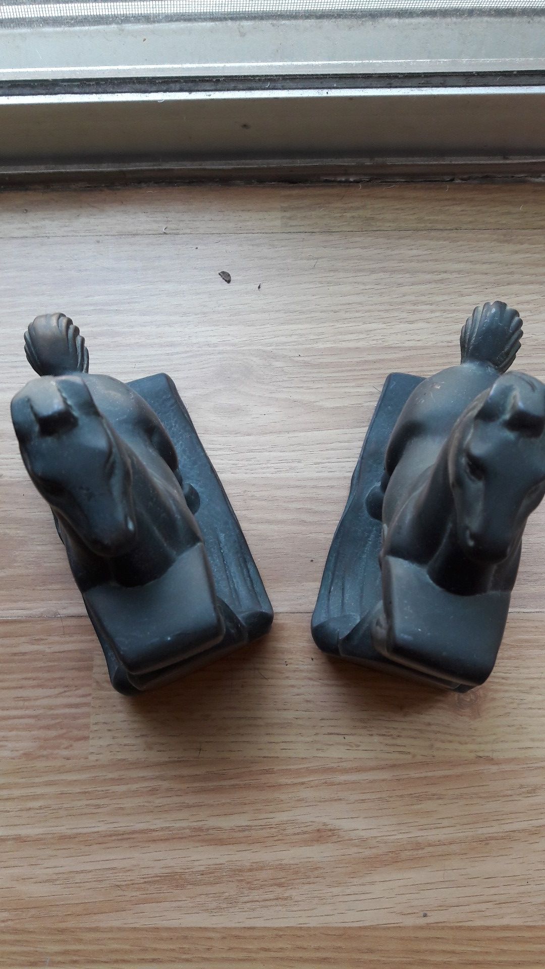 A pair of bronze horses bookend