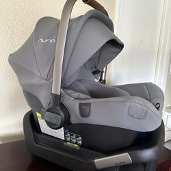 NUNA infant car seat along with base 