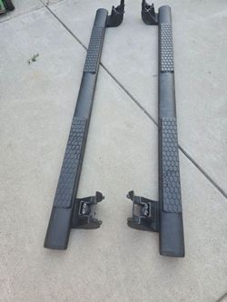 Black tubular side steps extending along the crew cab of the Dodge Ram.