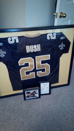 Authentic hand sighed Reggie bush professional framed Jersey with certificate of authenticity and picture of signing