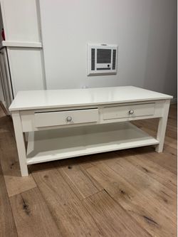 White Two-Drawer Coffee Table with Lower Shelf. Silver marble knobs. 43in L, 23in W, 18in H