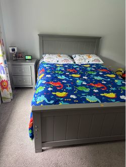 Grey wooden bed frame and mattress