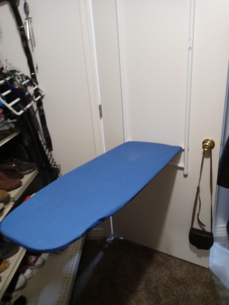 door hanging ironing board.