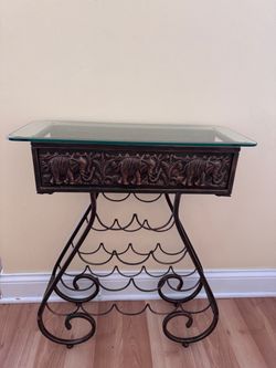Vintage metal wine rack with a glass tabletop