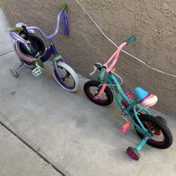Two Girls Bikes, One With Helmet Girls