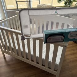 White Delta Crib, 5.5” mattress, and Safety Rail