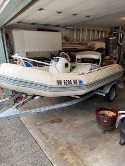 Zodiac 11ft. Inflatable. 1997 boat and motor.EZload trailer.