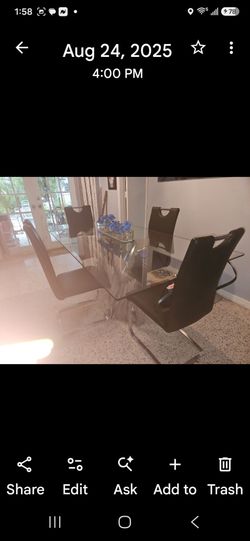 Modern stainless steel base and glass top dining table