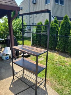 Kitchen or tool shelf.  Has hooks.  Black and brown.
