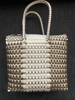Hand-woven gold and white plastic tote bag