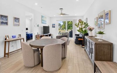 Modern Round Table and Four Beige Upholstered Side Chairs