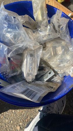Bucket of hardware still in the packages