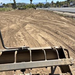 Grading weed clearing tractor work