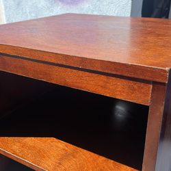 Side table with shelf and holes for cords