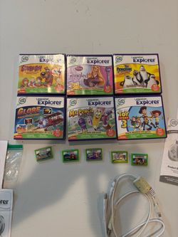 11 Leapster Explorer leapfrog games 6 w/ cases & inserts 5 loose  toy story Penguins Scooby Pixar  And miscellaneous cables and manuals no console