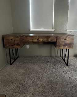Rustic industrial writing desk with solid wood finish and black metal hairpin legs. 