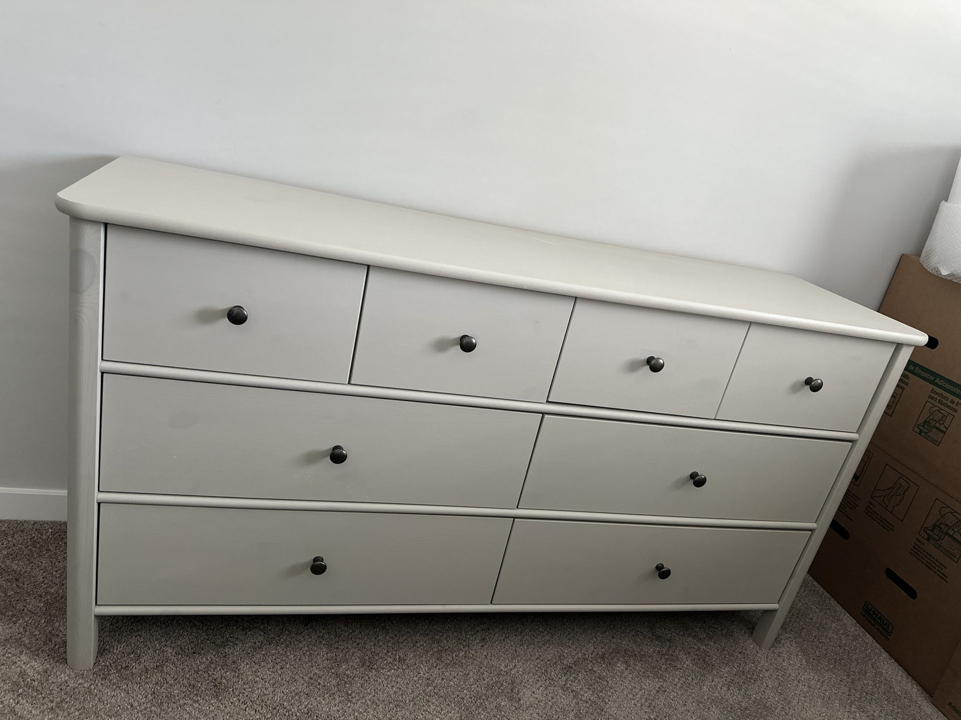 IKEA STOREMOLLA 8-drawer dresser in light grey-beige stained color.