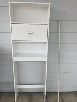 Behind toilet shelve