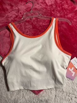White and orange sports bra