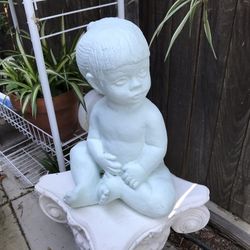 A cement litter girl garden statue 