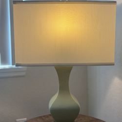Beautiful rustic-style table lamp with textured wood-look base and neutral fabric shade.  Warm, cozy lighting — perfect for bedroom, living room, gues