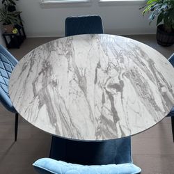 Marble Dining Table With 4 Blue Comfy Chairs