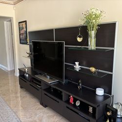 Black entertainment Center With Glass Shelves And Compartments For Storage