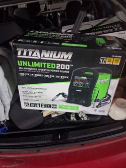 Titanium Unlimited 200 Multiprocess Welder with the welding helmet and spool gun