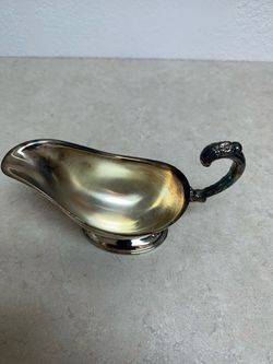 vintage silver-plated gravy boat with an ornate handle by International Silver.