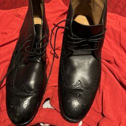 This is a pair of black leather Moral Code wingtip ankle boots, possibly the "Fazona2" model